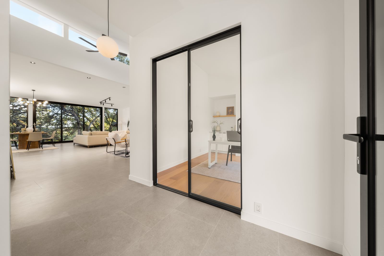 Bright entry with a glass-doored home office off the main living space